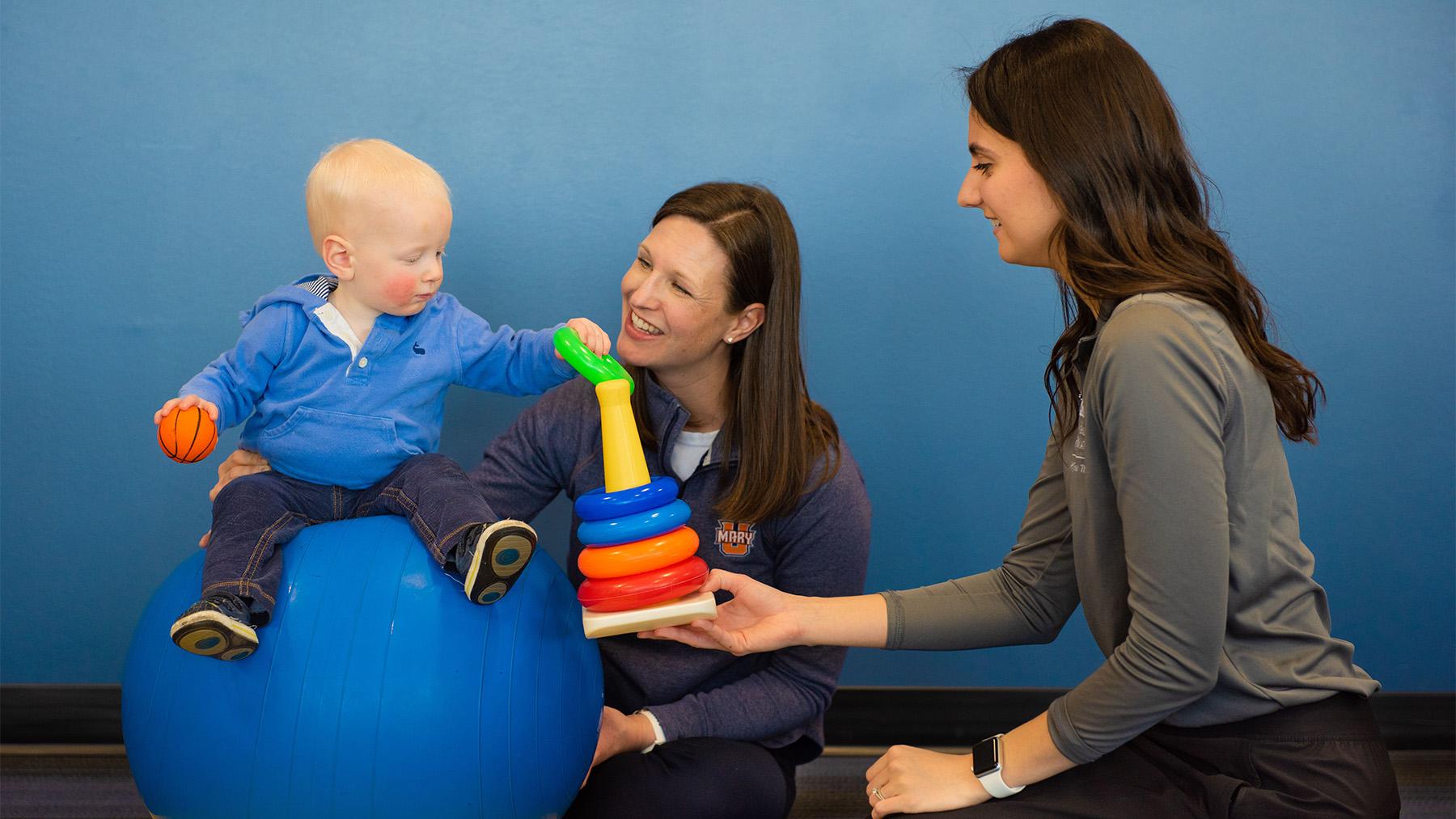 Physical therapy student working with a child