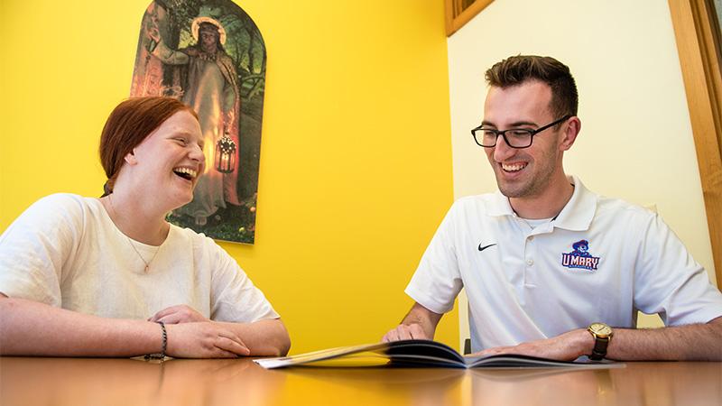 Admissions Representative with visiting student laughing together