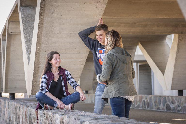 Alexa Leingang, left, chats with friends she met on University of Mary’s campus.