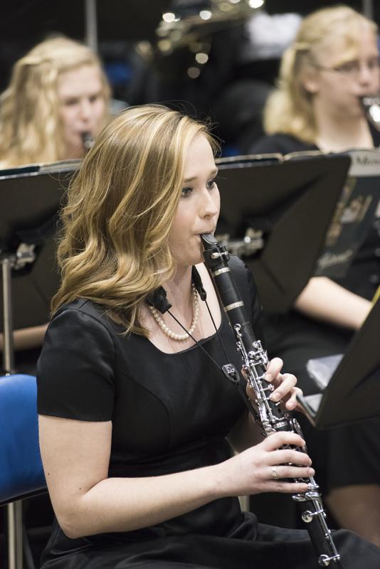 Woman playing clarinet in concert band.
