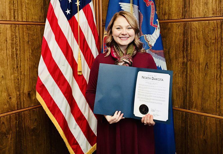 Megan Schneider holds ND Governor Doug Burgum’s Respiratory Care Week Proclamation at the State Capitol