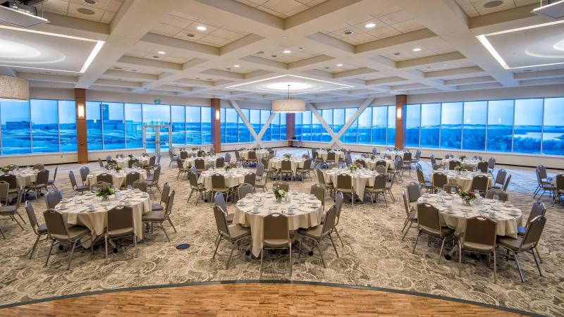 A view from the stage of Founders Hall looking to the back of wall-to-wall windows overlooking the Missouri River Valley.