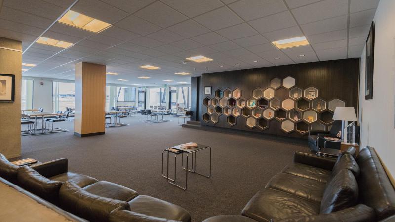 The Great Room includes a lounging space for guests with honeycomb shelving on the walls featuring memorabilia of its namesake and North Dakota entrepreneur Harold Schafer. 