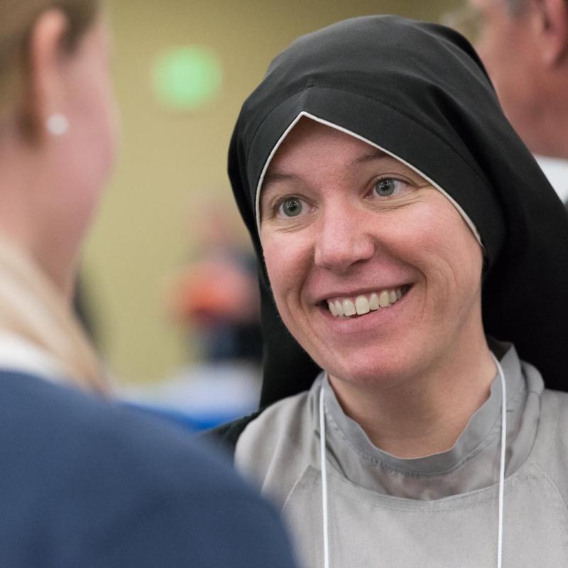 A visiting sister talking with a University of Mary student.