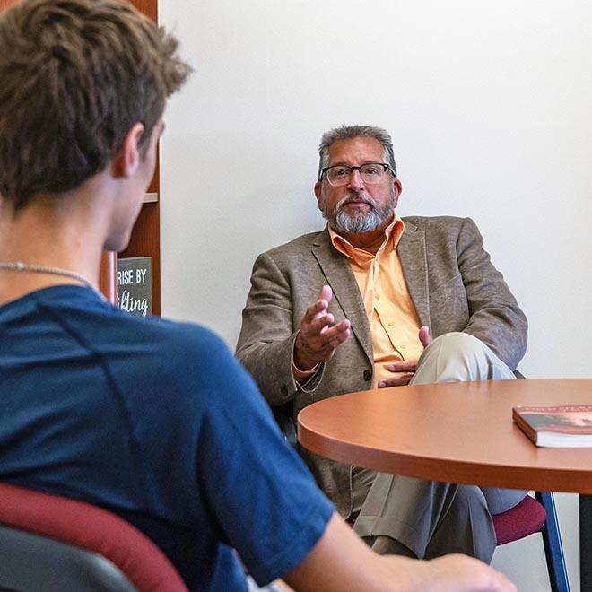 Karel Sovak mentoring a young college student.