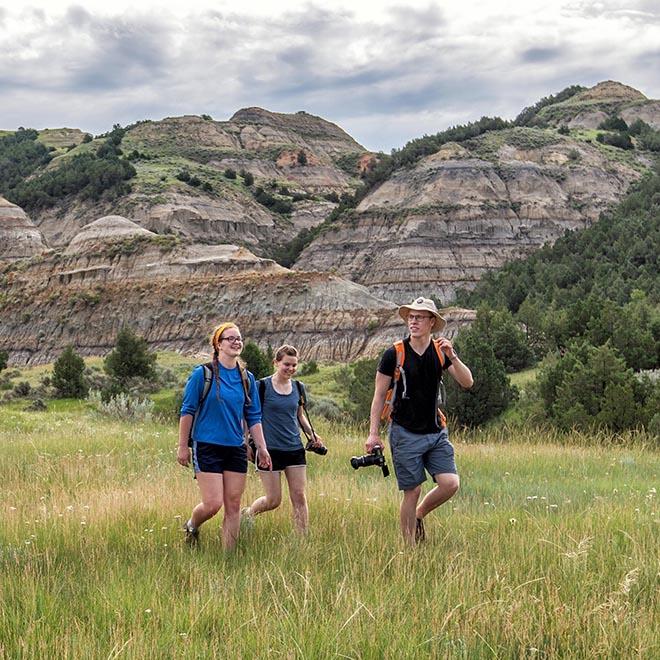 Three year-round campus students exploring the Badlands.