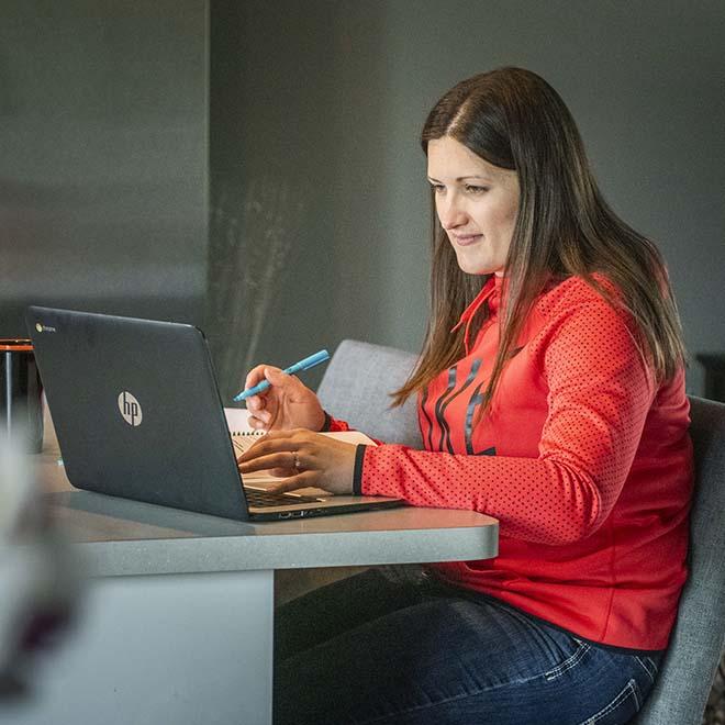 Adult student studying at kitchen counter at home