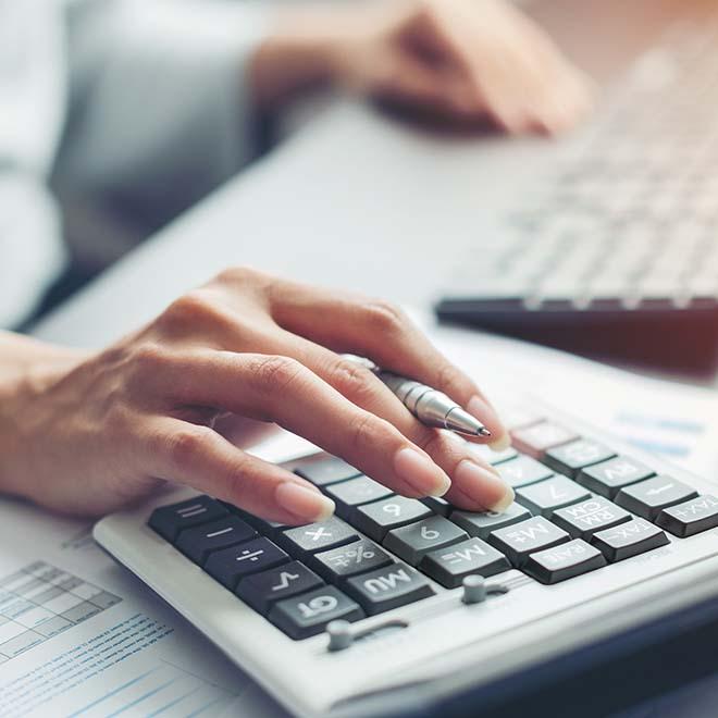 Closeup of woman’s hand on calculator