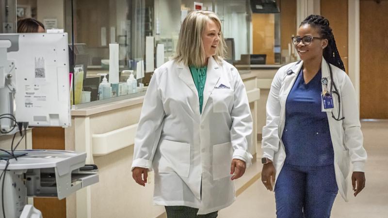 Dr. Billie Madler at hospital with University of Mary graduate nursing student.