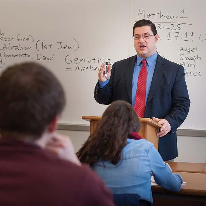 Dr. Leroy Huizenga in front of class giving a lecture