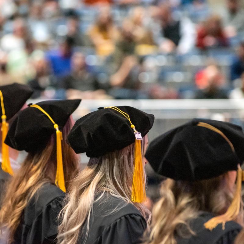 University of Mary graduates sitting at commencement