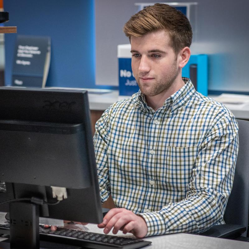 Student working in the on-campus banking center.