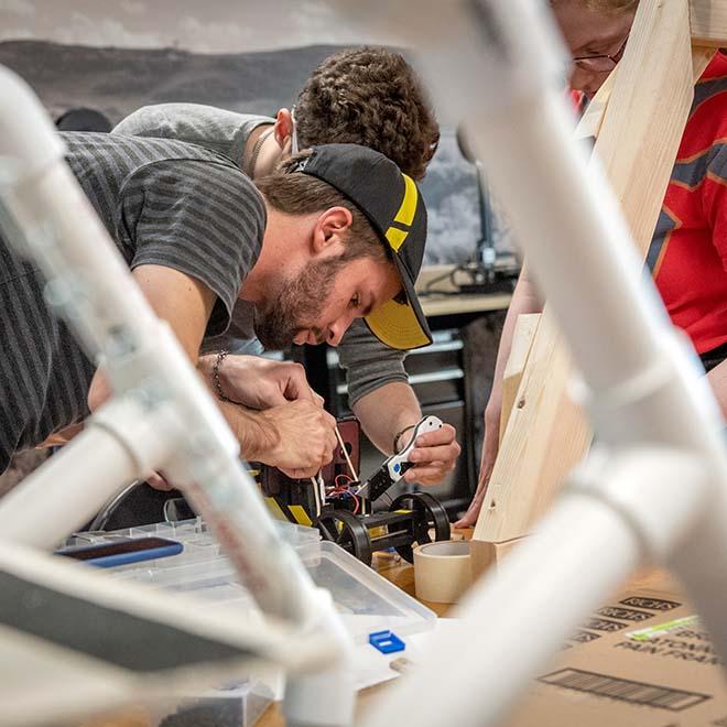 Engineering students working in shop