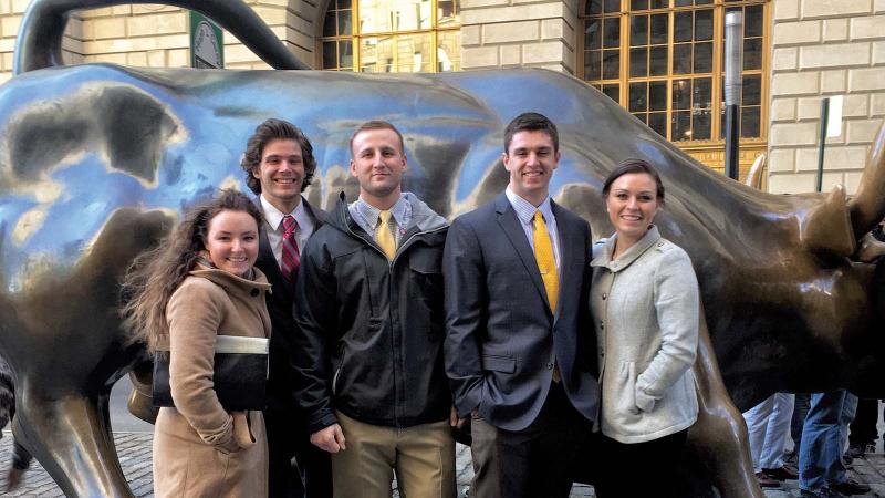 Investment Club students visiting the Charging Bull on Wall Street in New York City