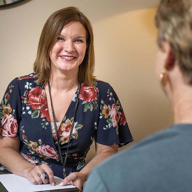 Mental health counselor talking with a patient.