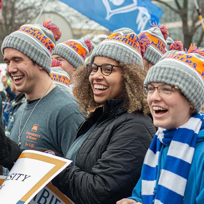 Joyful University of Mary students wearing matching stocking caps at the national March for Life event in Washington D.C.