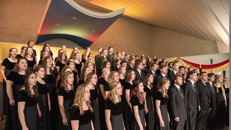 Large choral group performing in the Our Lady of the Annunciation Chapel