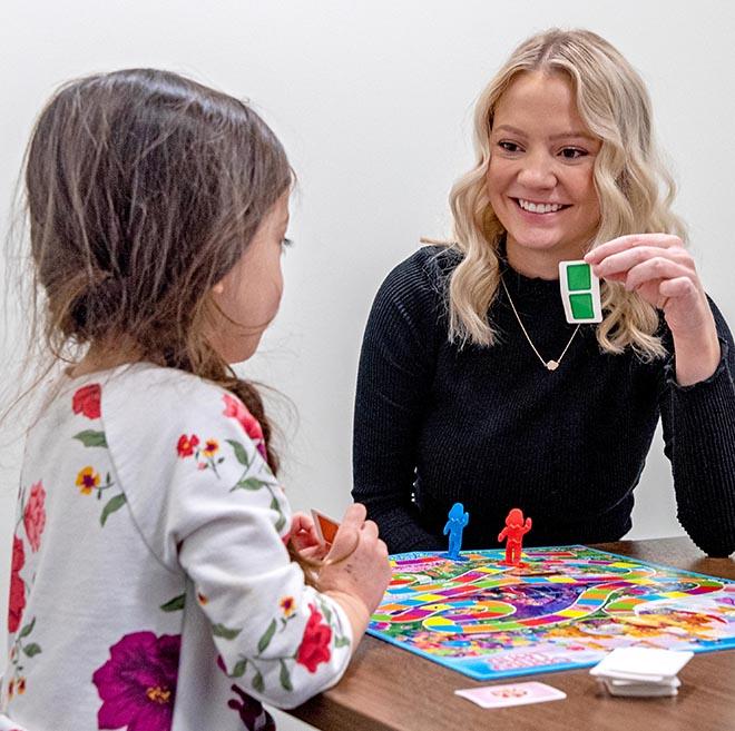 Speech-language pathology student working with a child.