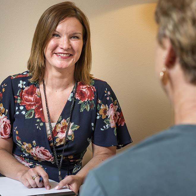 Smiling counselor meeting with female patient