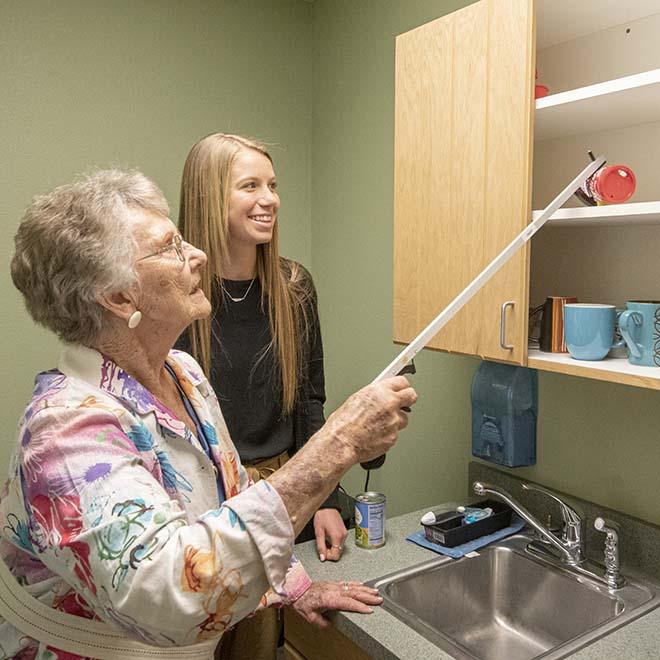 Occupational Therapy student working with elderly patient at pro bono clinic