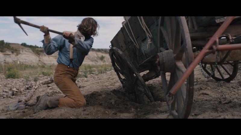 Man digging out his wagon
