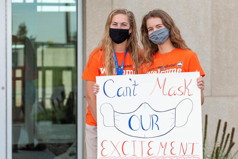 Students with Sign for Welcome Week