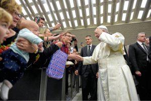 University of Mary Rome Campus student Chris Riedman (in red shirt) smiles as Pope Francis accepts his zucchetto then takes off his own zucchetto to exchange with Riedman