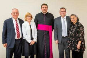 Patrick Reilly, second from right, poses with family and University Mary President Monsignor James Shea 