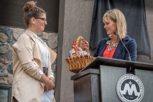 Student Shanna Stevenson, a junior from Woodbury, MN, accepts house warming gift after speaking on behalf of her fellow residents