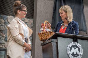 ​​​​​​​Student Shanna Stevenson, a junior from Woodbury, MN, accepts house warming gift after speaking on behalf of her fellow residents