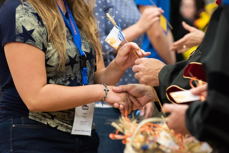 Students receiving the wheat stalk