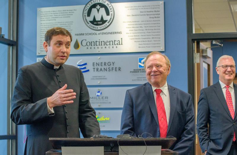 Monsignor Shea and Harold Hamm speaking at the Hamm School of Engineering dedication.