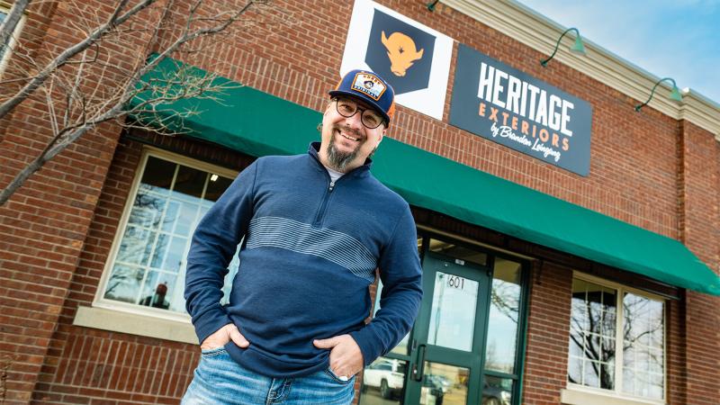 Brandon Leingang in front of his store front