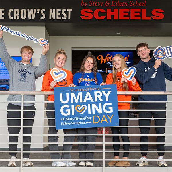 Students holding a Giving Day sign