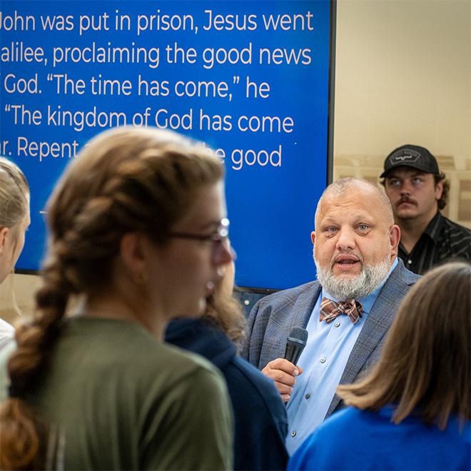 Large group of students gathered for worship and to listen to speakers