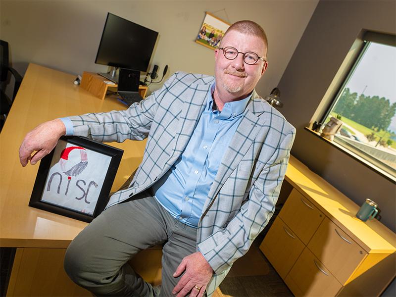 Doug with a drawing of the NISC logo