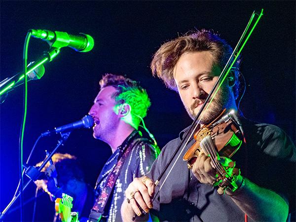 Mat Charley playing the fiddle while Mark Race sings
