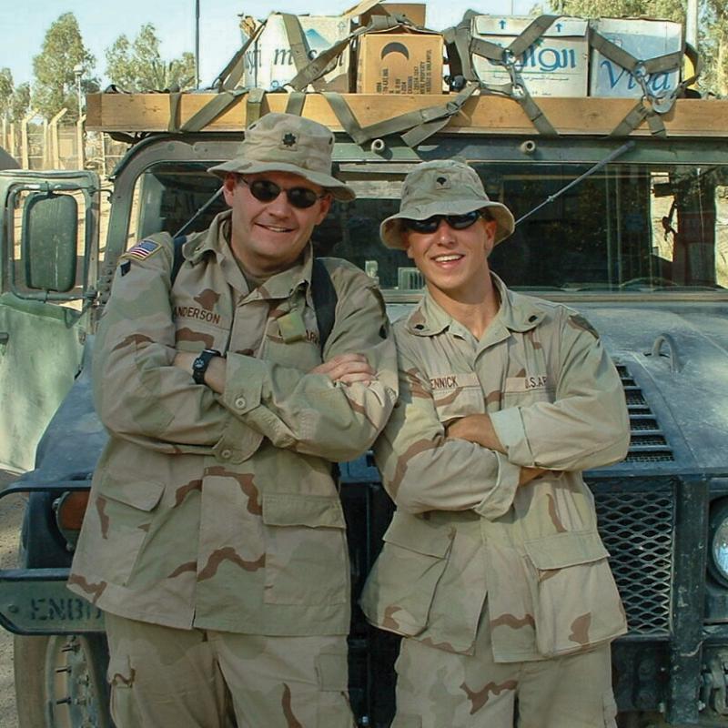 Dave Anderson with a fellow military man next to a truck