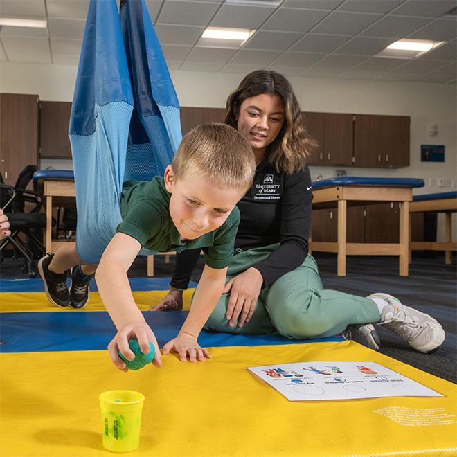 Student working with a child during their clinic session