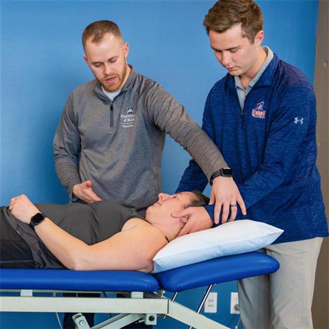 PT student with a professor practicing