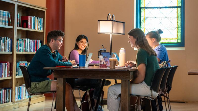 student studying at the Newman Center Library at Mary College