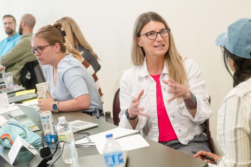 Rural school superintendent Teresa Risovi talks with another member of her doctoral cohort during their on-campus summer institute.