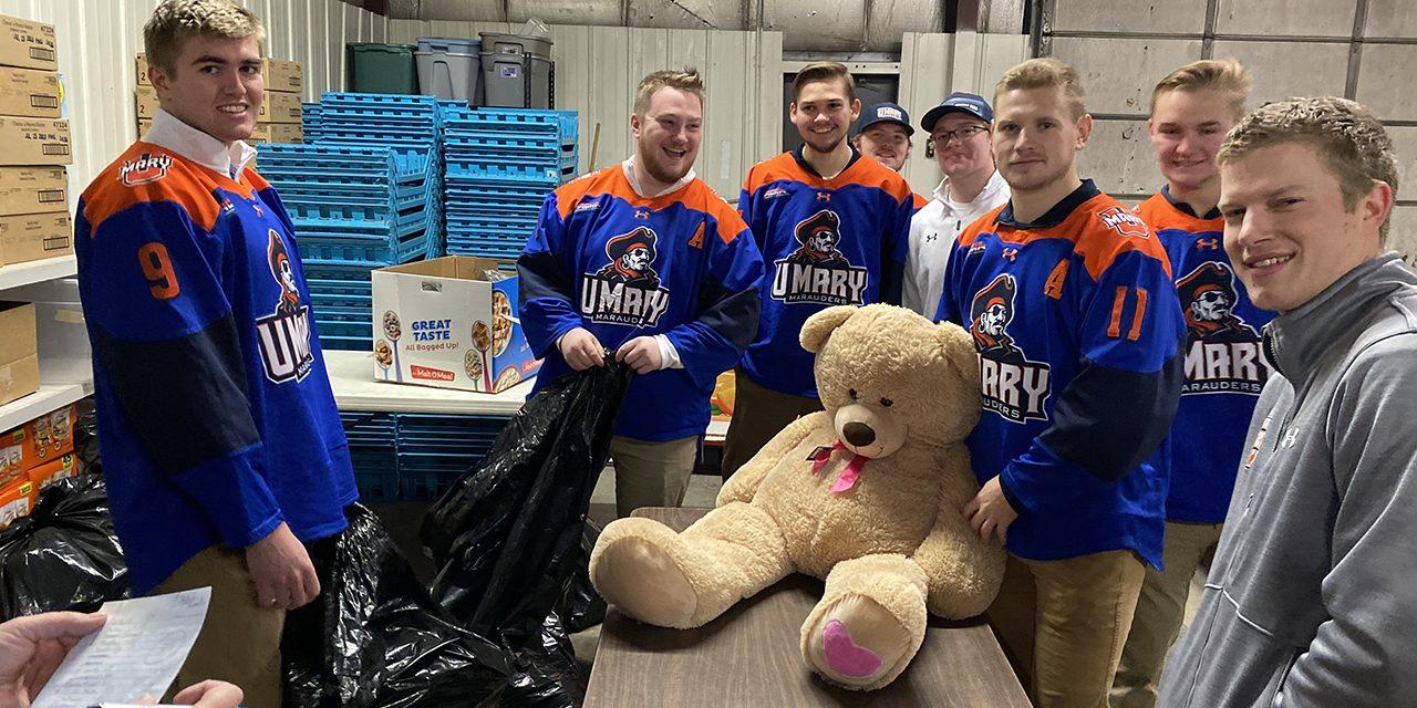 Marauders Hockey Team Volunteering with Teddy Bear Toss