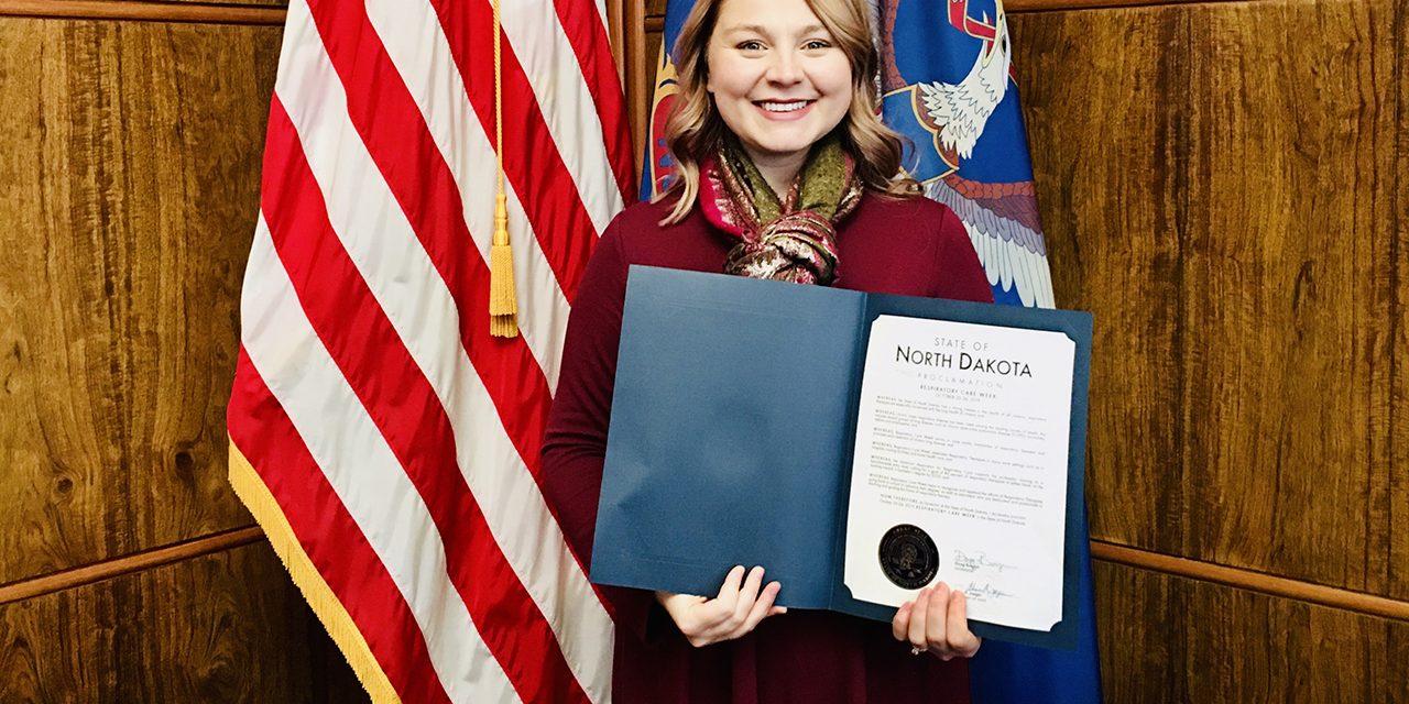 Megan Schneider holds ND Governor Doug Burgum’s Respiratory Care Week Proclamation at the State Capitol