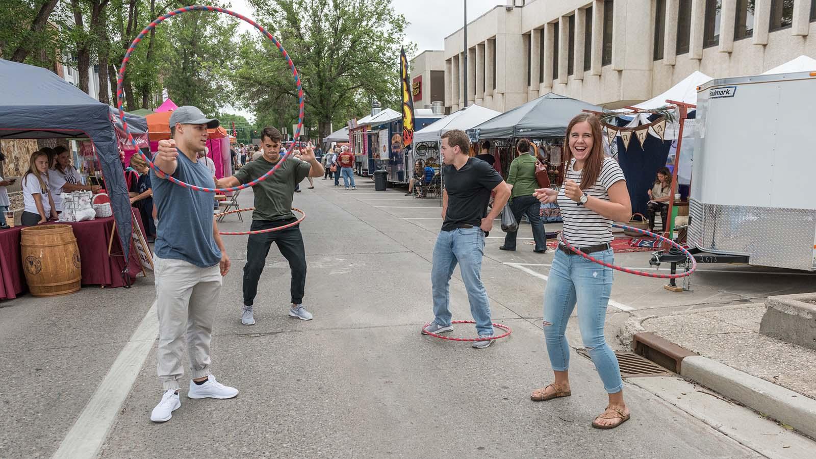 Group of University of Mary students hula hooping at downtown Bismarck street fair