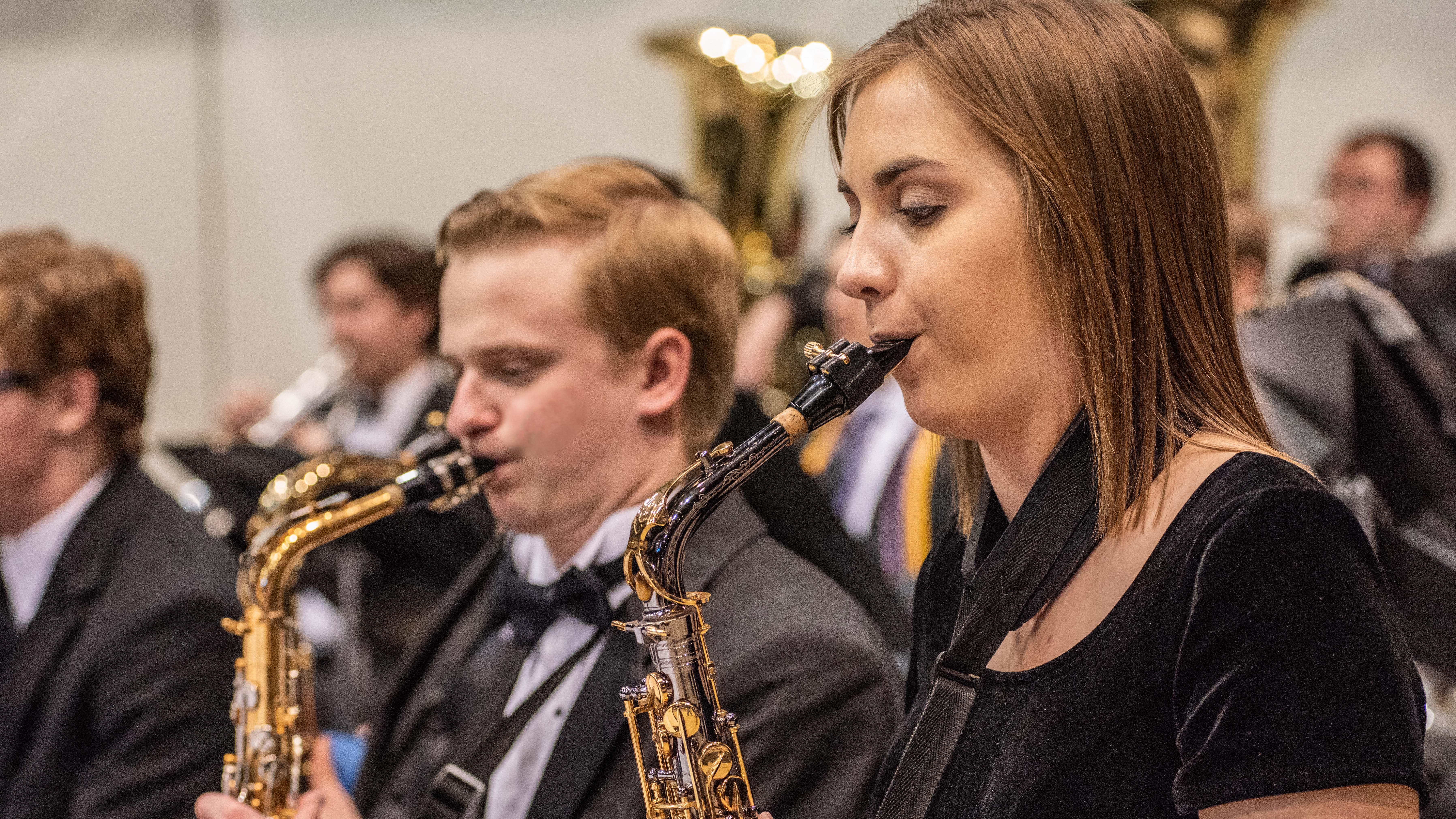 Two saxophone players participating in concert band at commencement