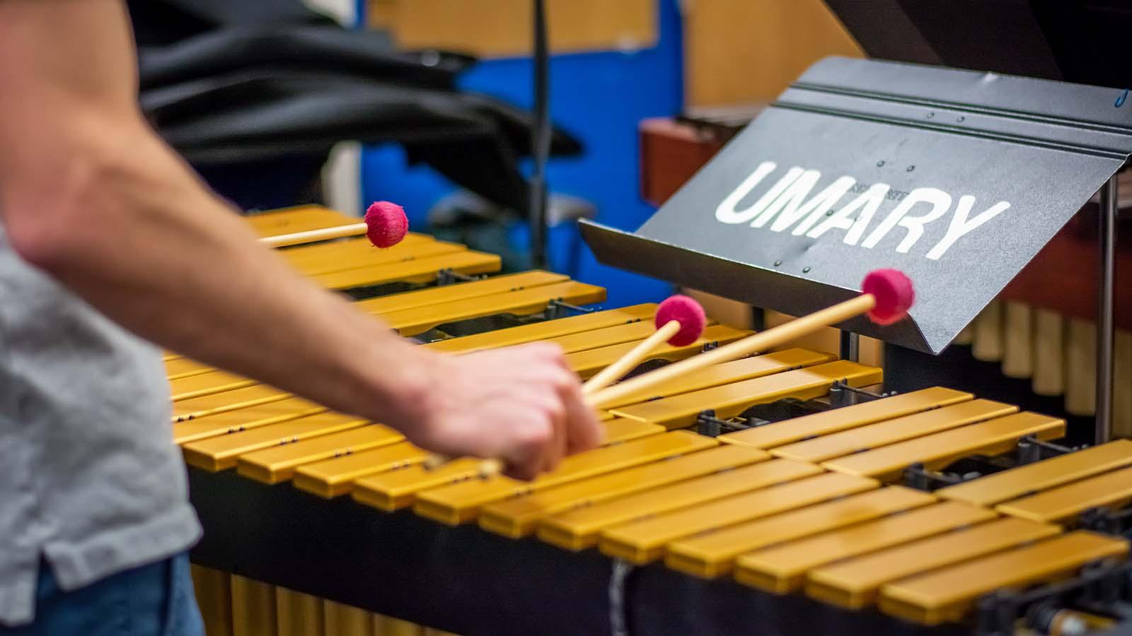 Closeup of student playing xylophone