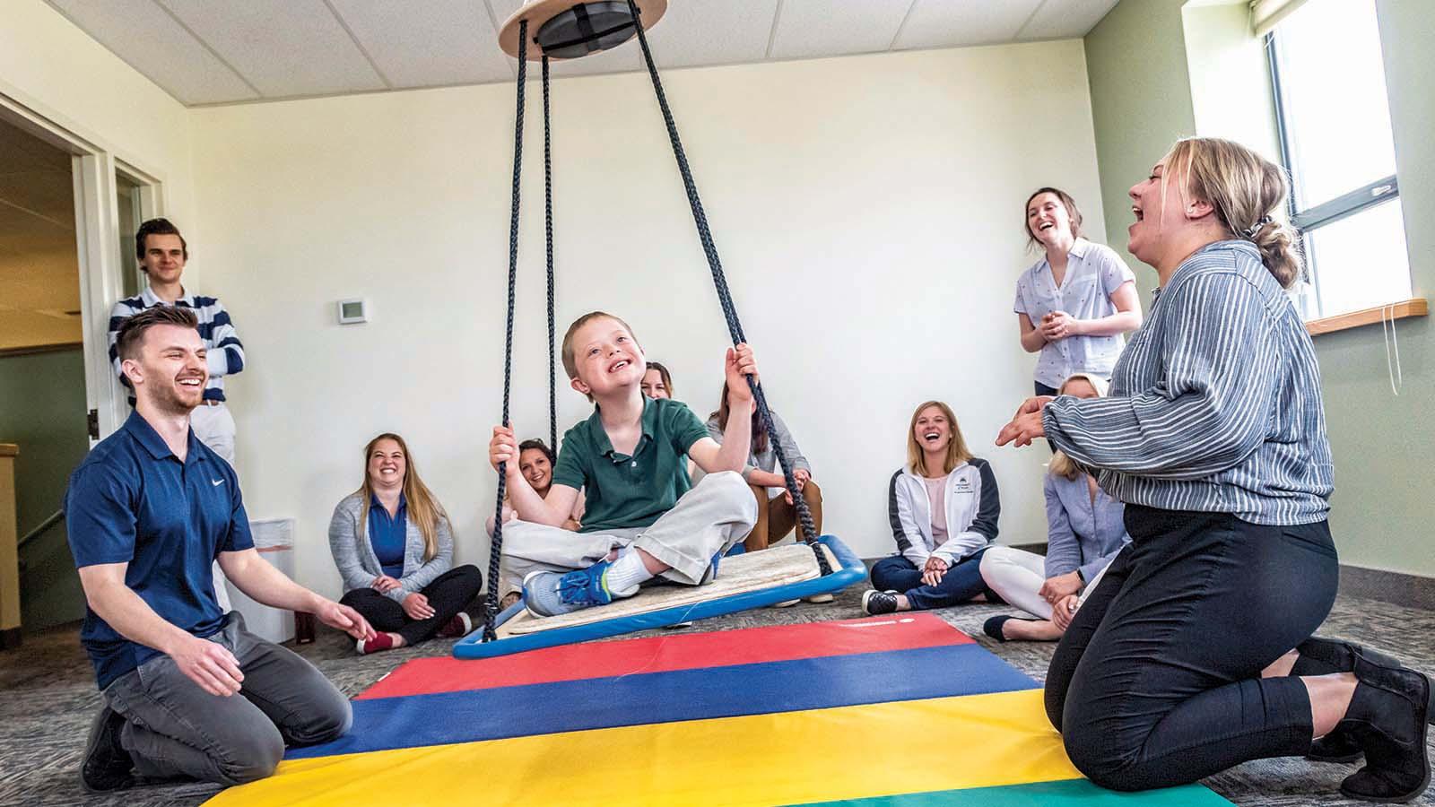 OT students in pro bono clinic with a child patient