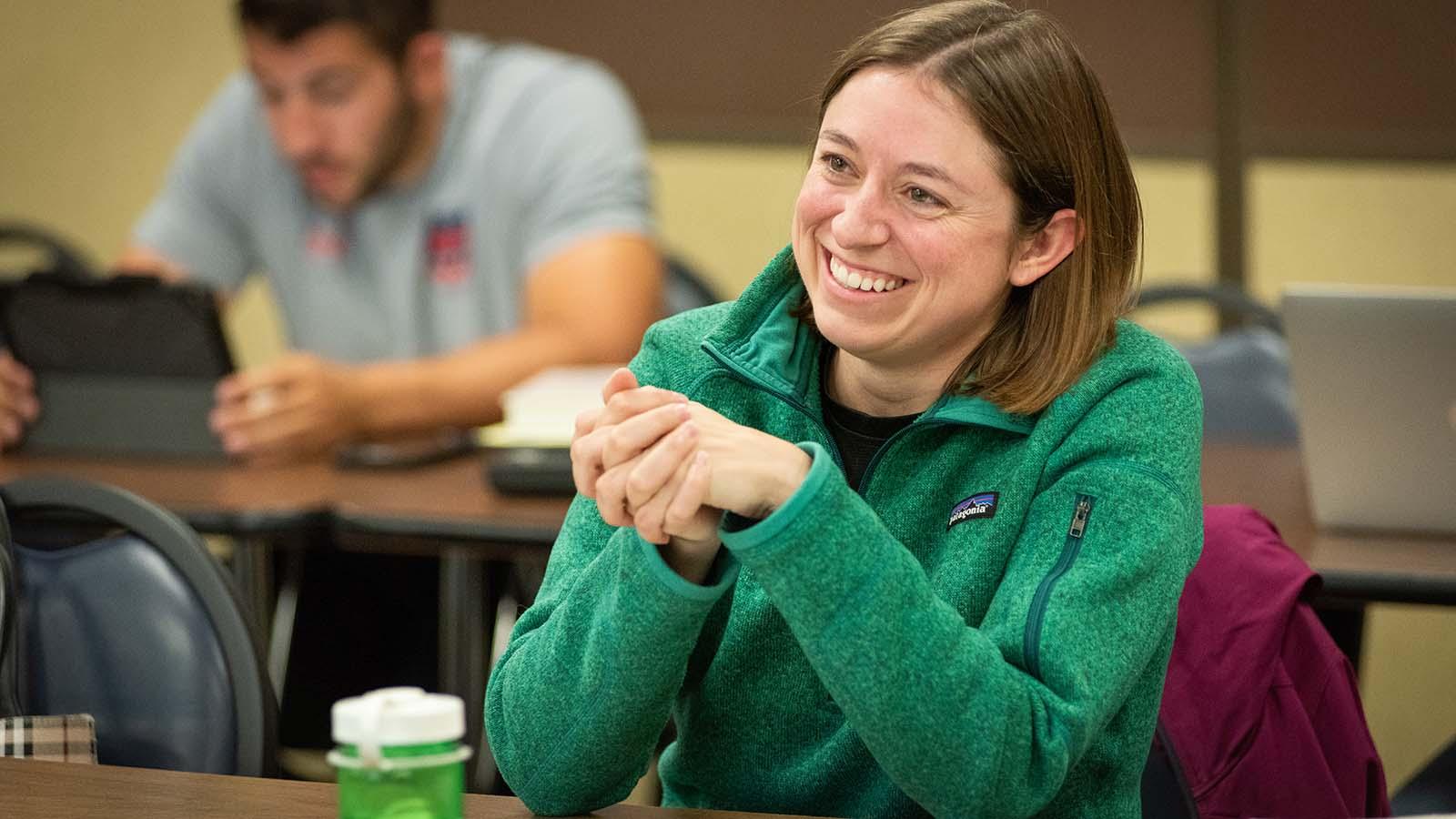 Alt text: Smiling adult student in class 