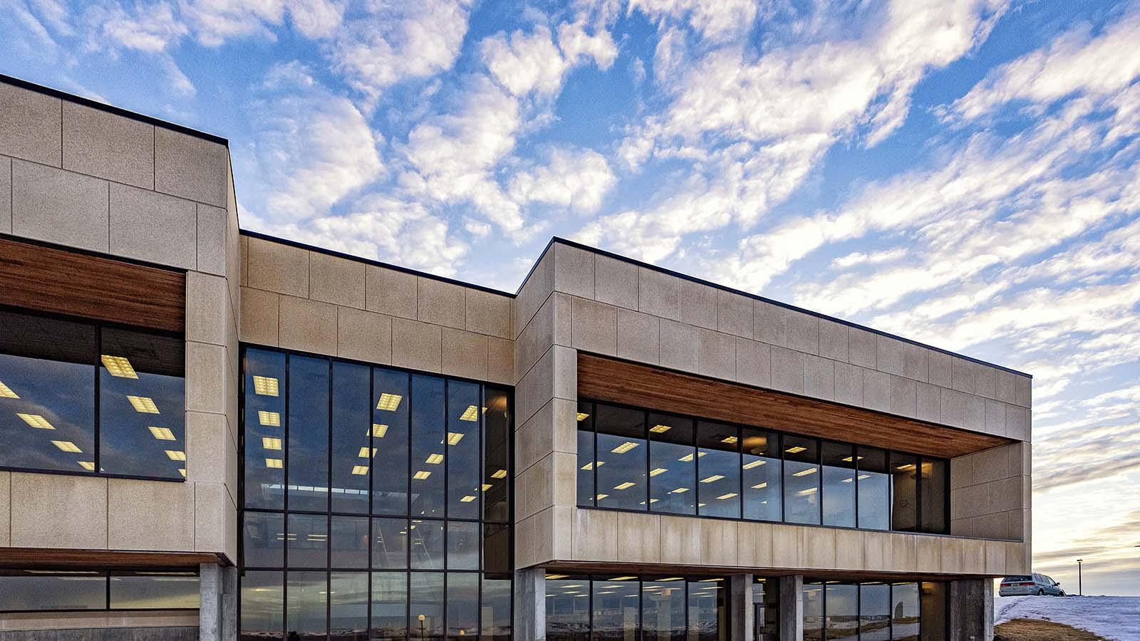 West side of Welder Library with large sky and clouds in the background.